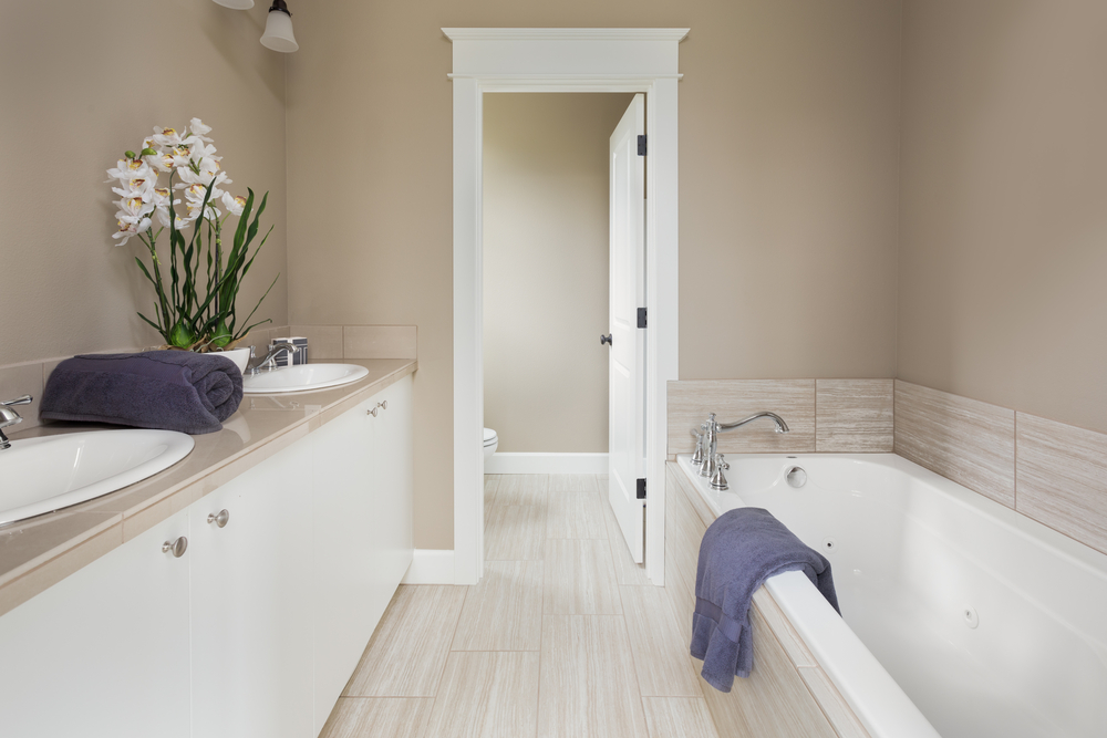 Master Bathroom with double vanity and bathtub in new luxury home